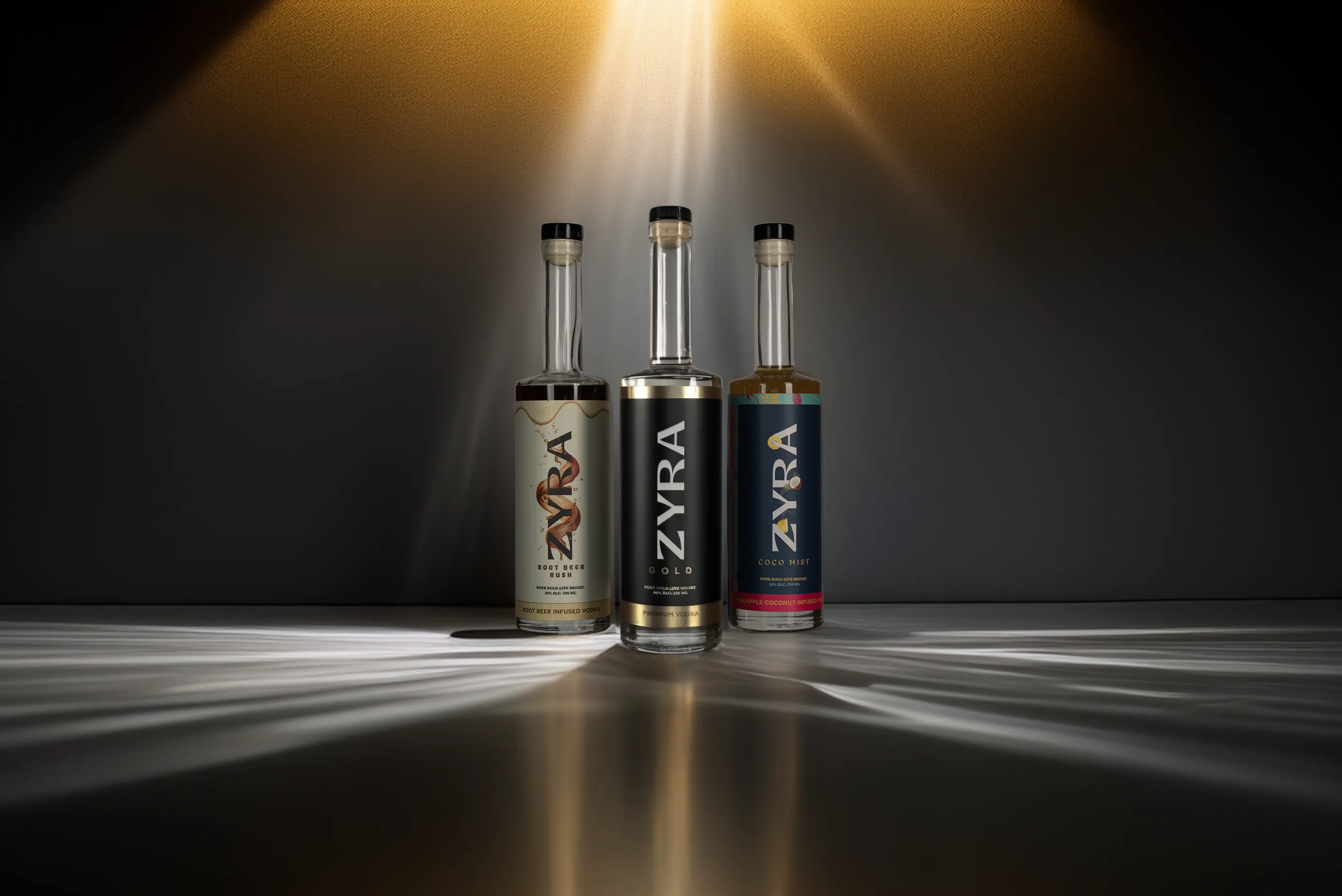 The Zyra Vodka lineup: Gold, Coco Mist, and Root Beer Rush bottles side by side